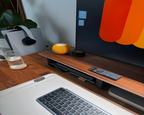 Close up of a keyboard and monitor in a cozy home office setting
